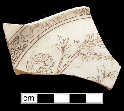 Plate. Unglazed bisque waster. Transfer printed  floral motif in brown. 4.6 mm thick